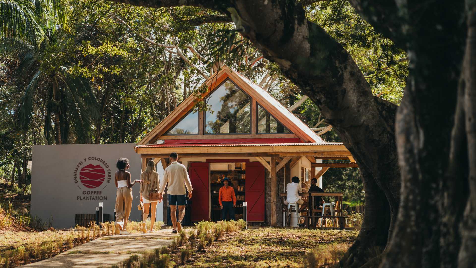 People Walking Towards The Coffee Plantation Shops